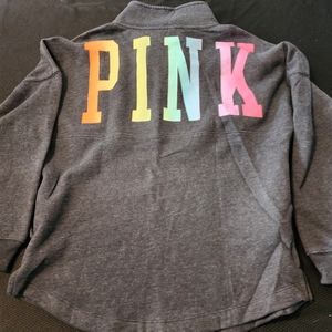 Pink quarter zip sweatshirt with rainbow colored pink writing